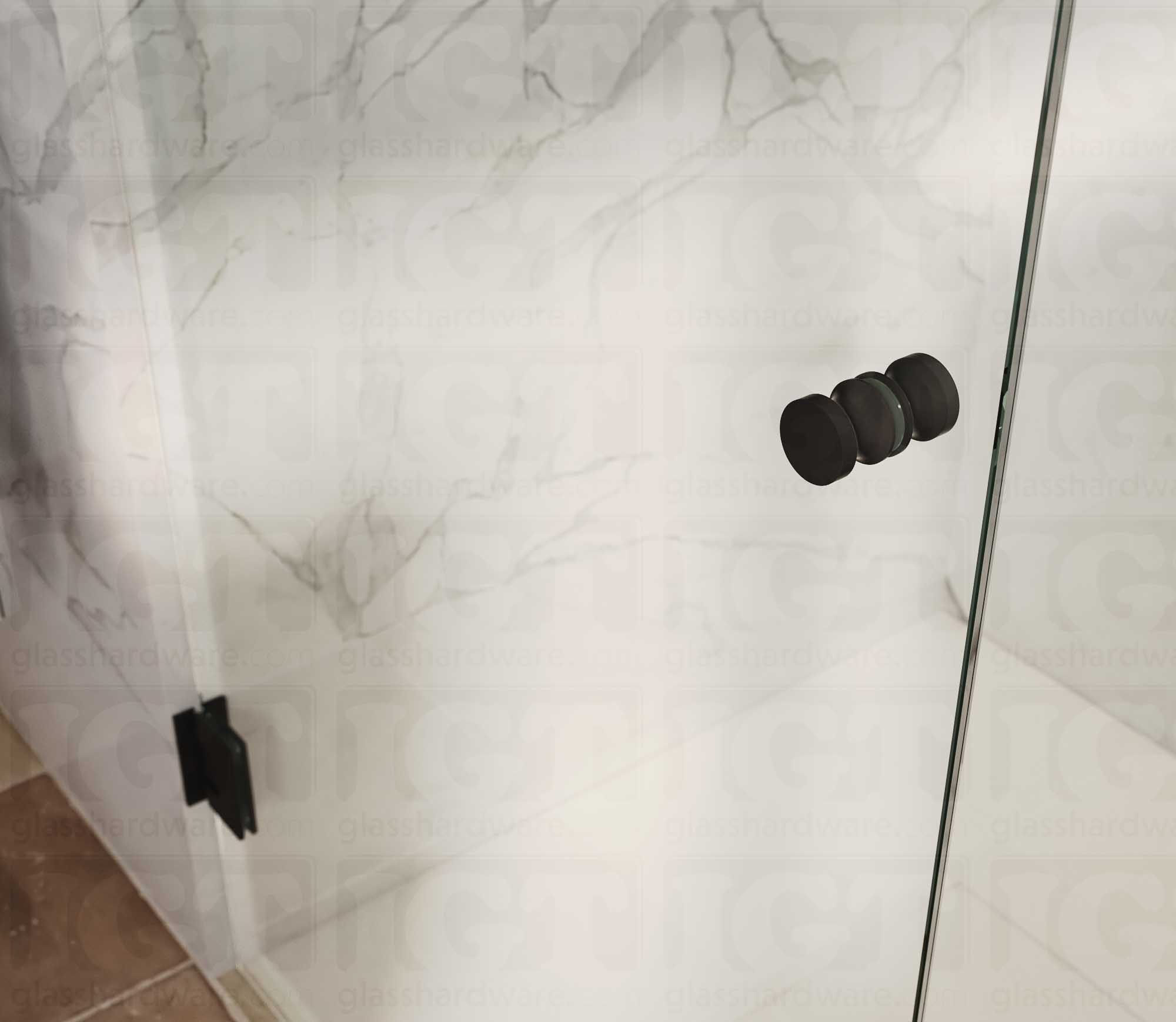 A close up of the European Style Back-to-Back Door Knob installed on a glass shower door. Matte Black.