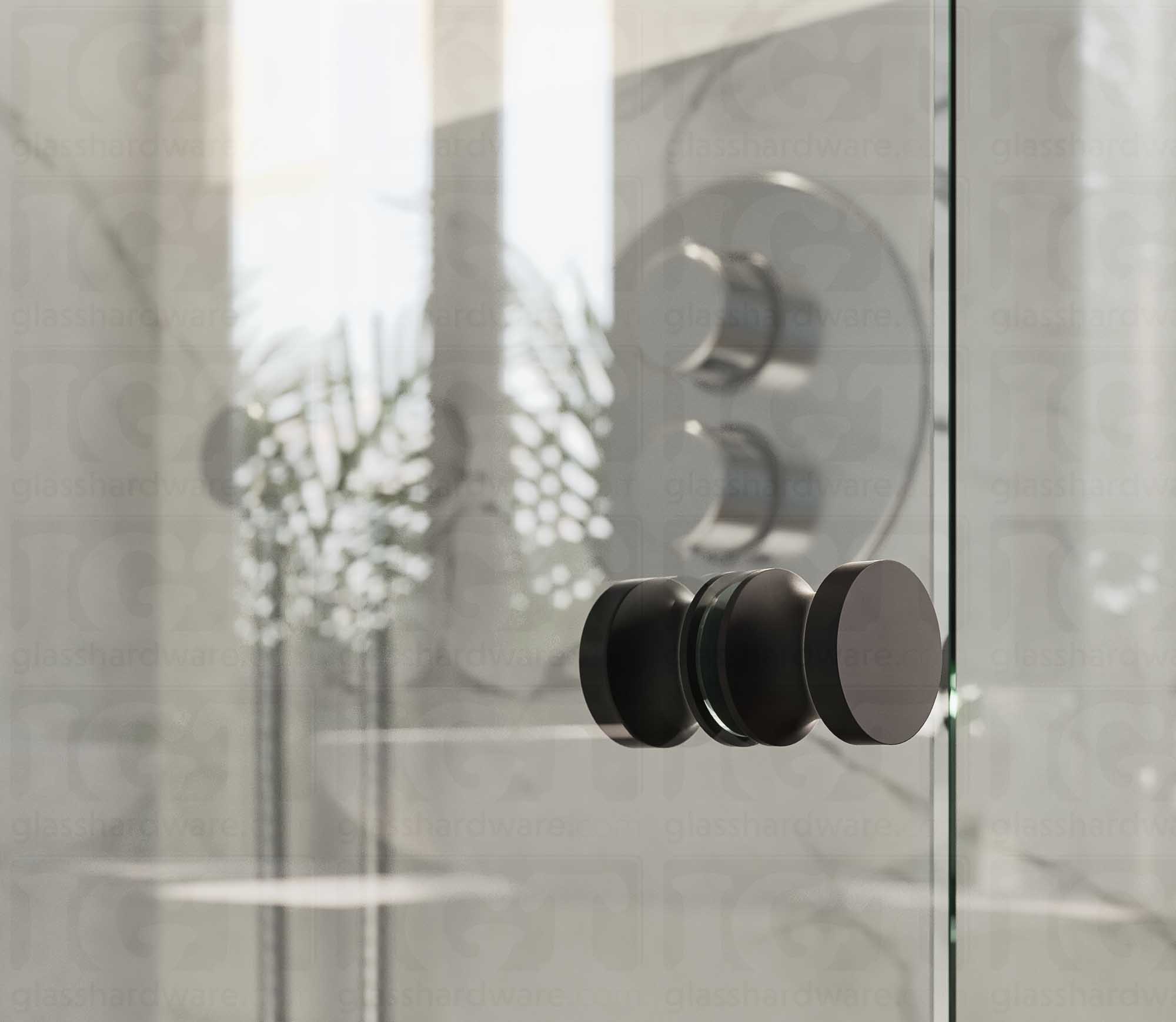 A close up of the European Style Back-to-Back Door Knob installed on a glass shower door. The door knob's back-to-back design is tightly secured to the glass door. Matte Black.