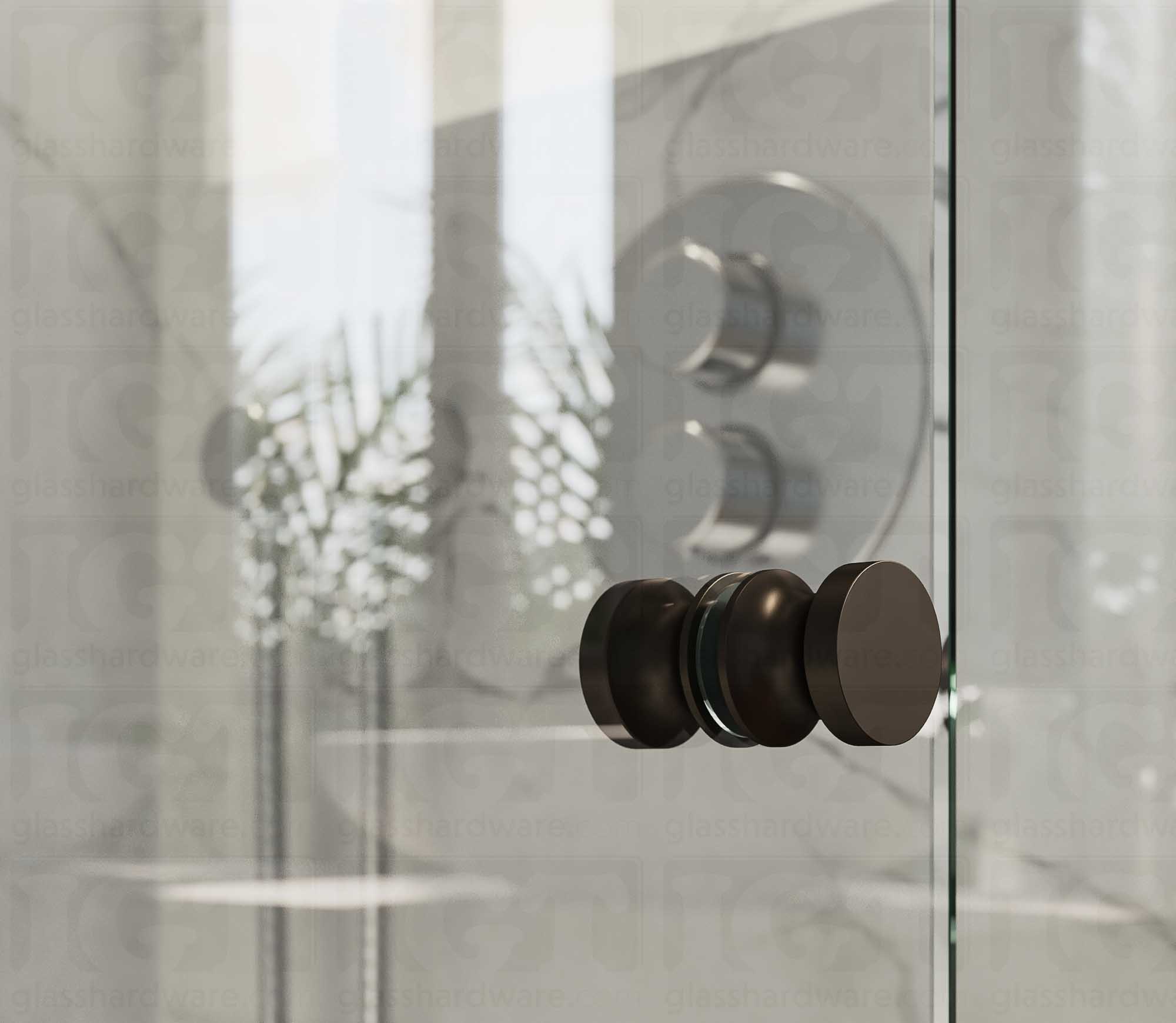 A close up of the European Style Back-to-Back Door Knob installed on a glass shower door. The door knob's back-to-back design is tightly secured to the glass door. Oil Rubbed Bronze.