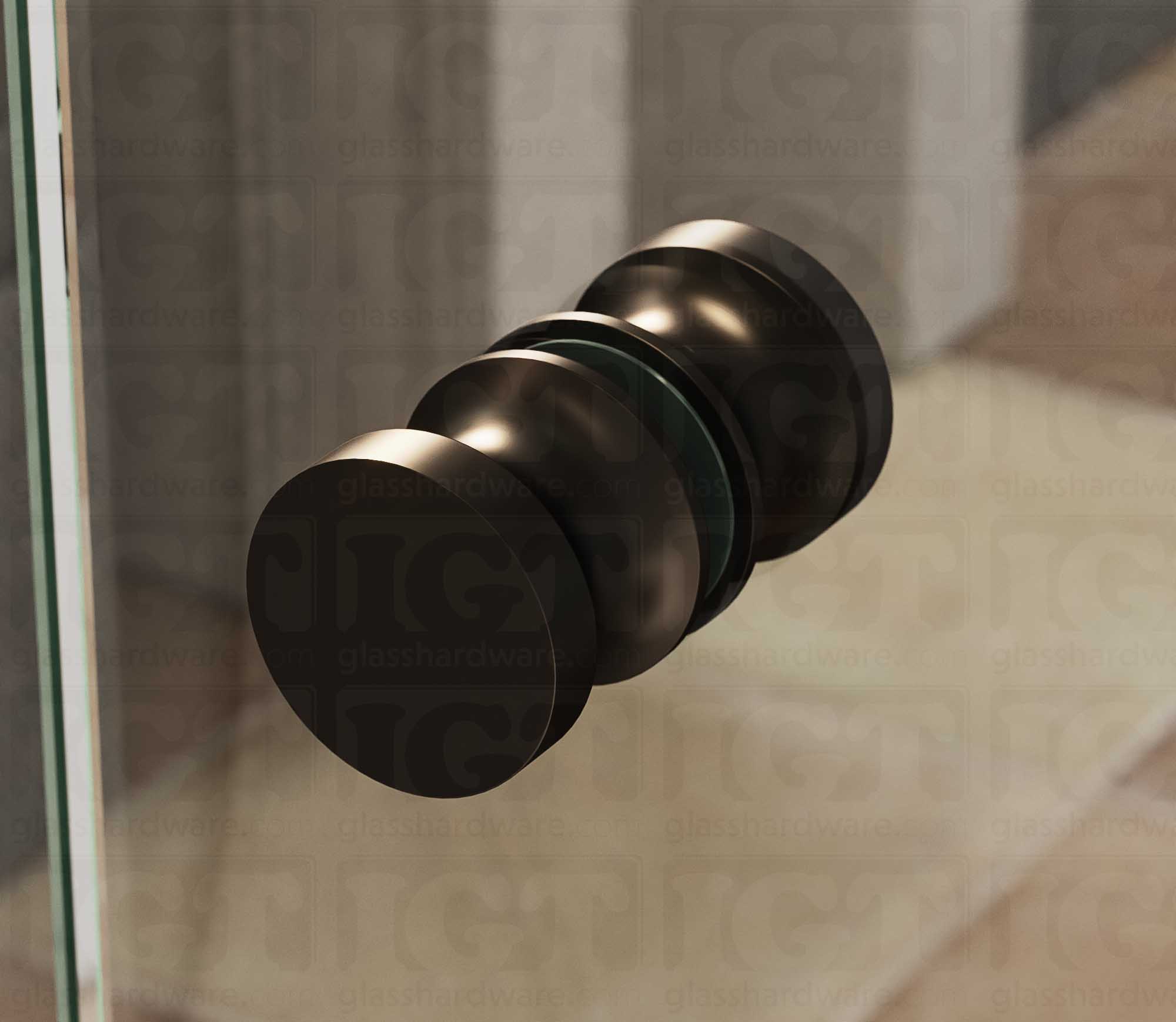 A close up of the European Style Back-to-Back Door Knob installed on a glass shower door. Soft natural light highlights the knob's Oil Rubbed Bronze finish.