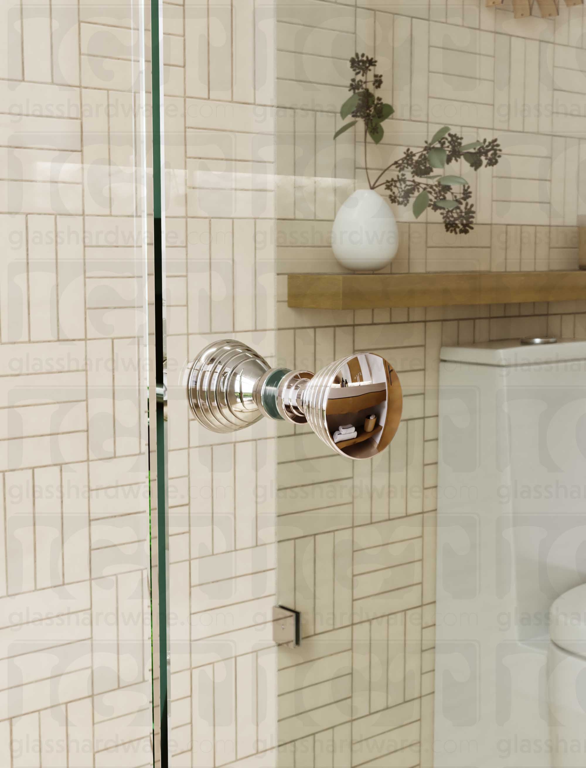 A close up of the Ribbed Bow Tie Style Back-to-Back Door Knob installed on a glass shower door. The door knob's back-to-back design is tightly secured to the glass door. Chrome Polished.