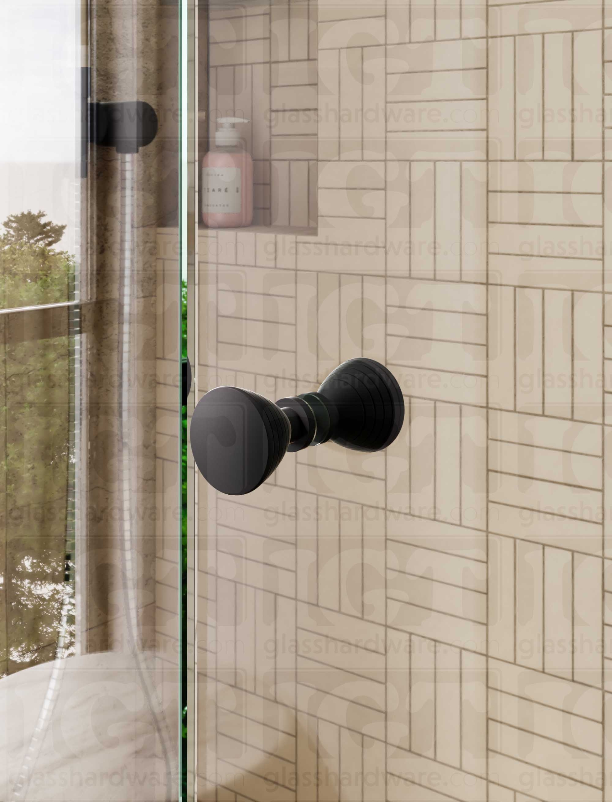 A close up of the Ribbed Bow Tie Style Back-to-Back Door Knob installed on a glass shower door. Matte Black.