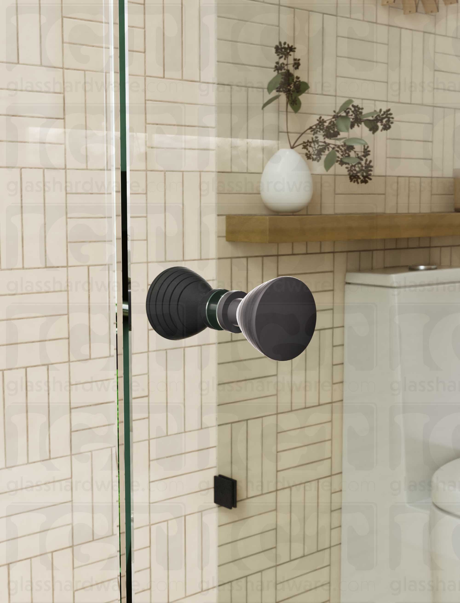 A close up of the Ribbed Bow Tie Style Back-to-Back Door Knob installed on a glass shower door. The door knob's back-to-back design is tightly secured to the glass door. Matte Black.