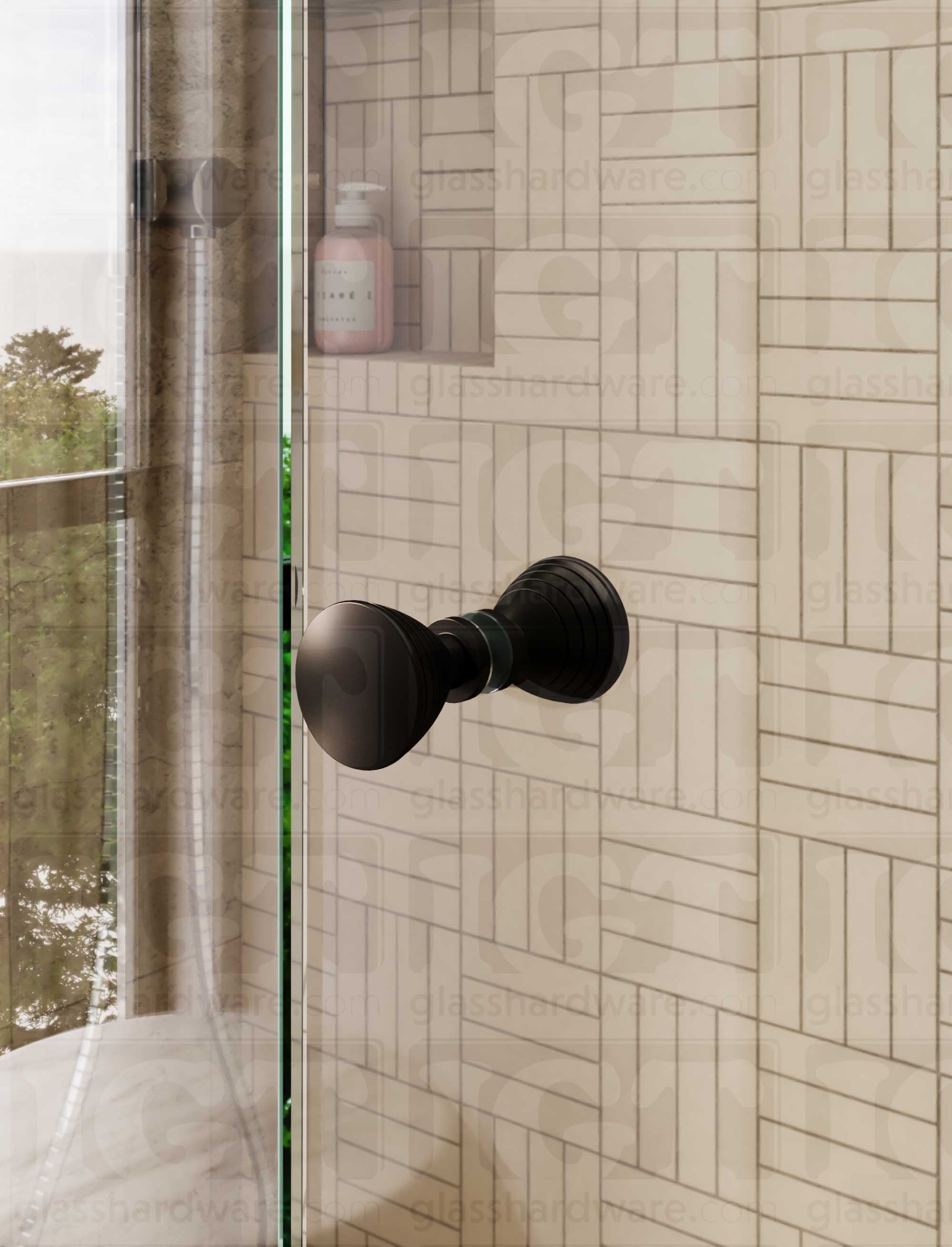 A close up of the Ribbed Bow Tie Style Back-to-Back Door Knob installed on a glass shower door. Oil Rubbed Bronze.