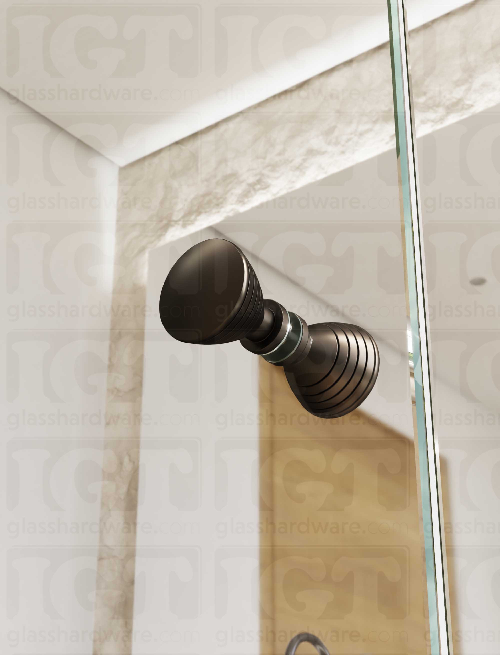 A close up from below of the Ribbed Bow Tie Style Back-to-Back Door Knob installed on a glass shower door. Soft natural light highlights the knob's Oil Rubbed Bronze finish.