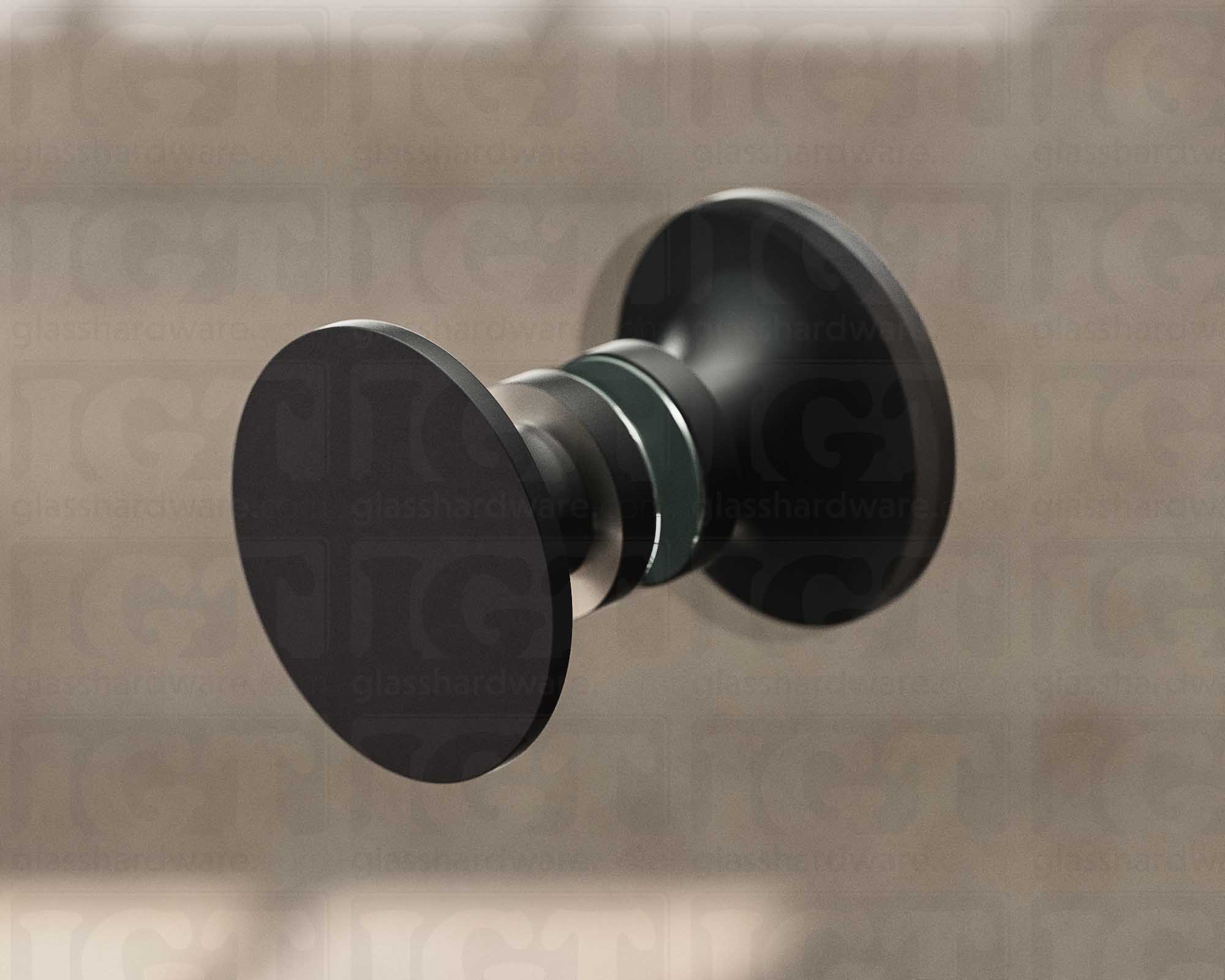 A close up of the Traditional Style Back-to-Back Door Knob installed on a glass shower door. Soft natural light highlights the knob's Matte Black finish.