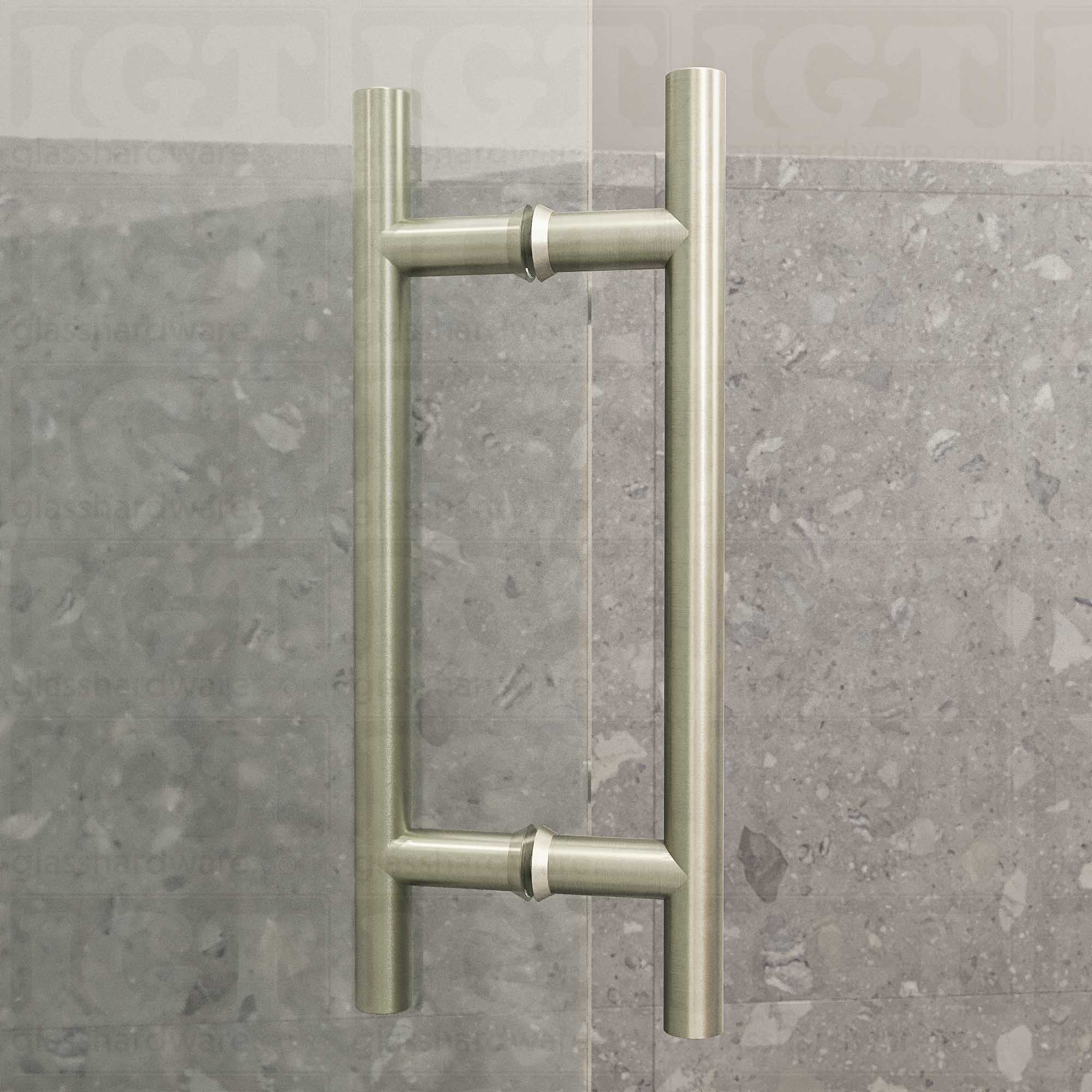 An angled close-up of the 8" Center-to-Center Round Ladder Handle installed on a frameless glass shower door, showing its 304 Stainless Steel construction in more detail. Brushed Nickel.