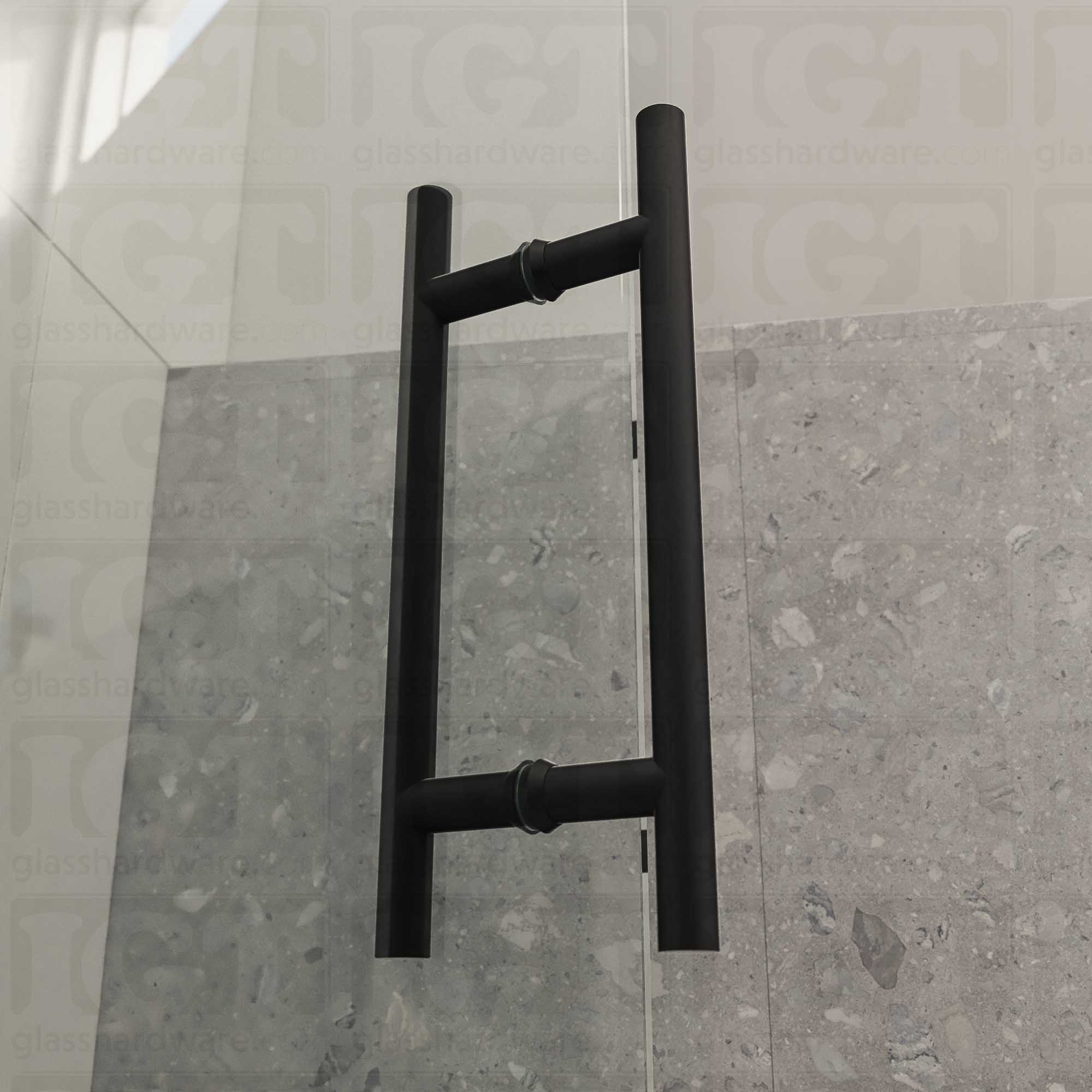 An angled close-up of the 8" Center-to-Center Round Ladder Handle installed on a frameless glass shower door, showing its 304 Stainless Steel construction in more detail. Matte Black.