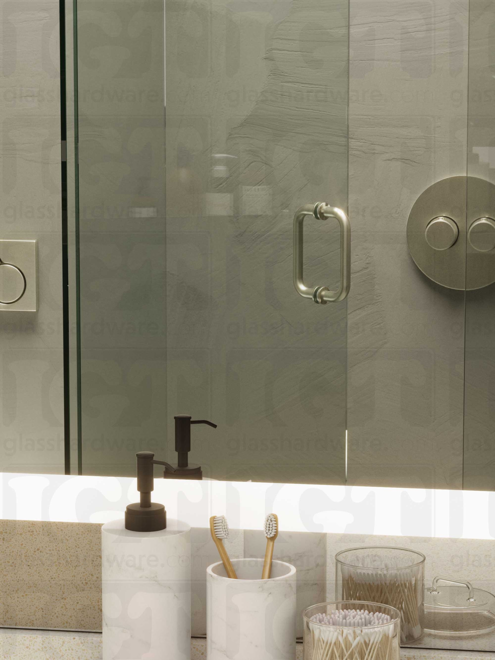 A frameless glass shower door in the open position, featuring the 6" Round Pull Handle. Brushed Nickel.