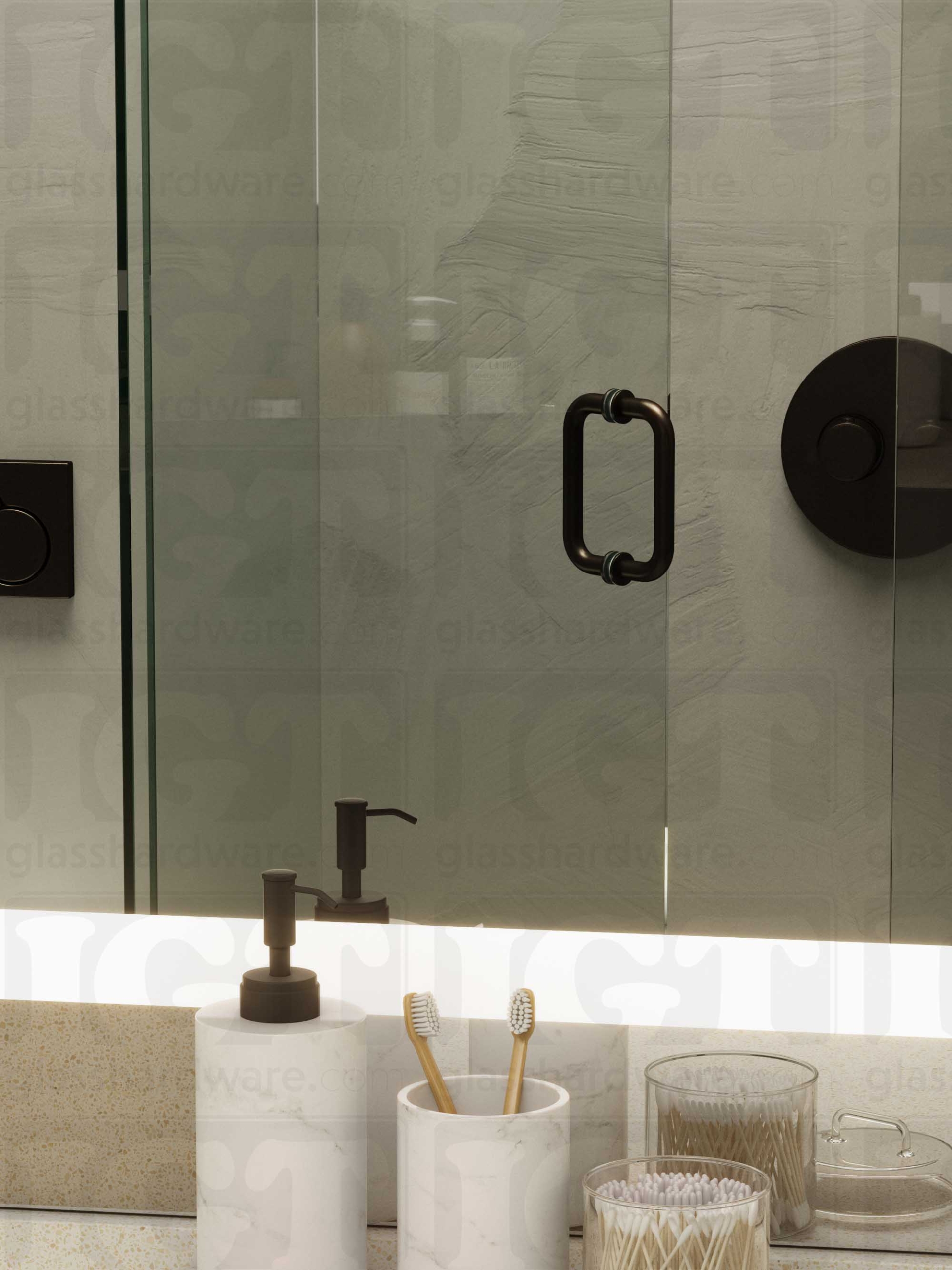 A frameless glass shower door in the open position, featuring the 6" Round Pull Handle. Oil Rubbed Bronze.