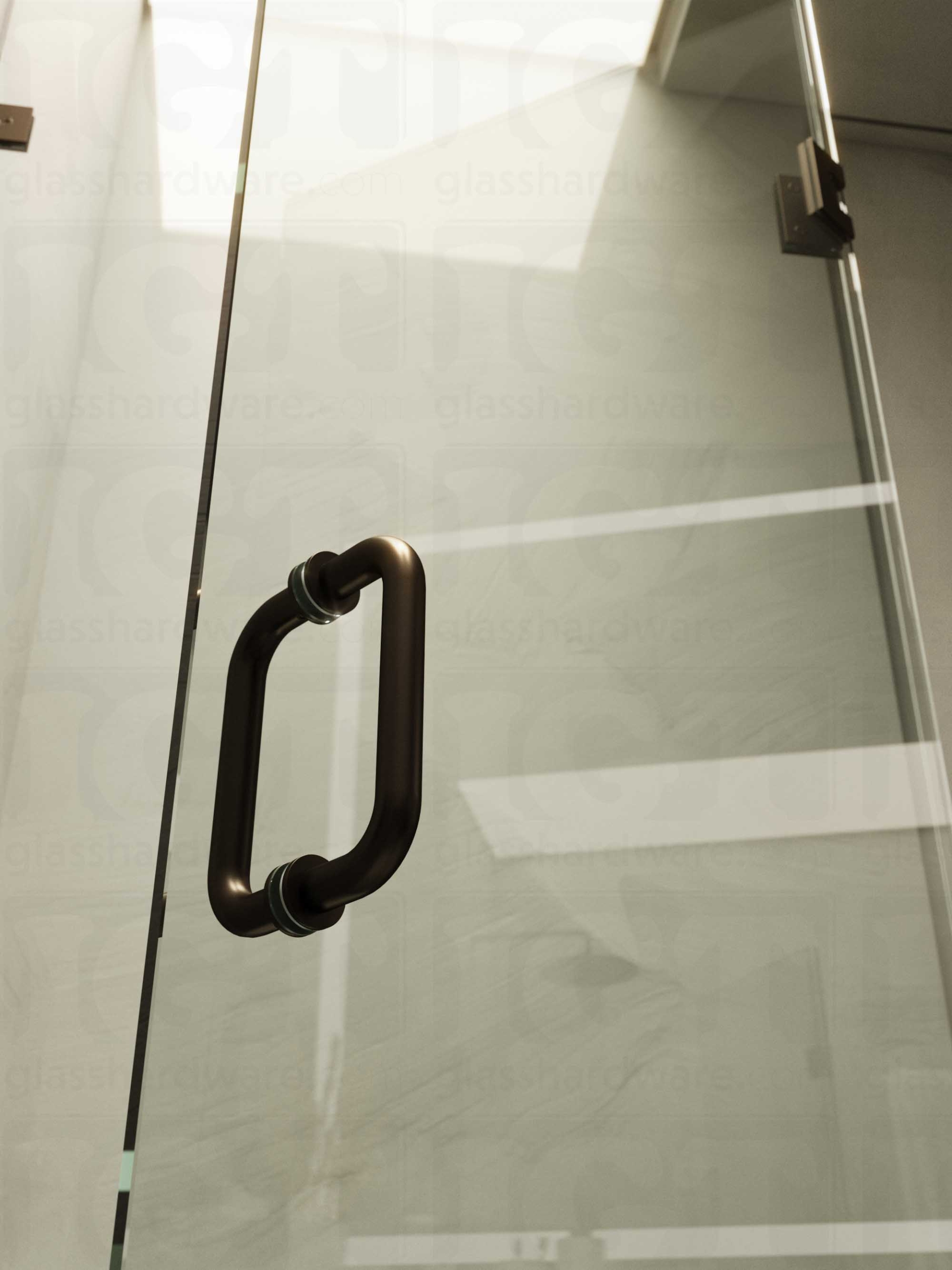 A close-up of the 6" Round Pull Handle installed on a frameless glass shower door, showcasing it's 304 Stainless Steel construction. Oil Rubbed Bronze.