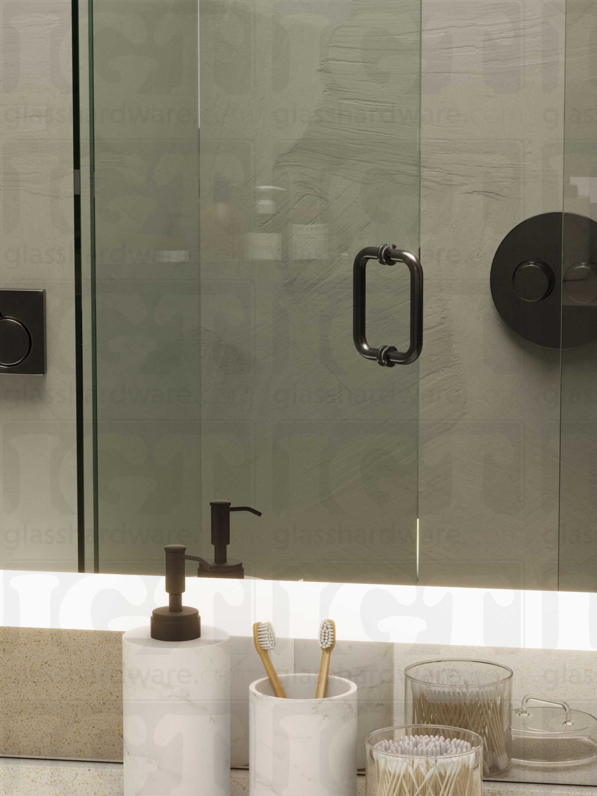 A frameless glass shower door in the open position, featuring the 6" Round Pull Handle. Polished Gun Metal.