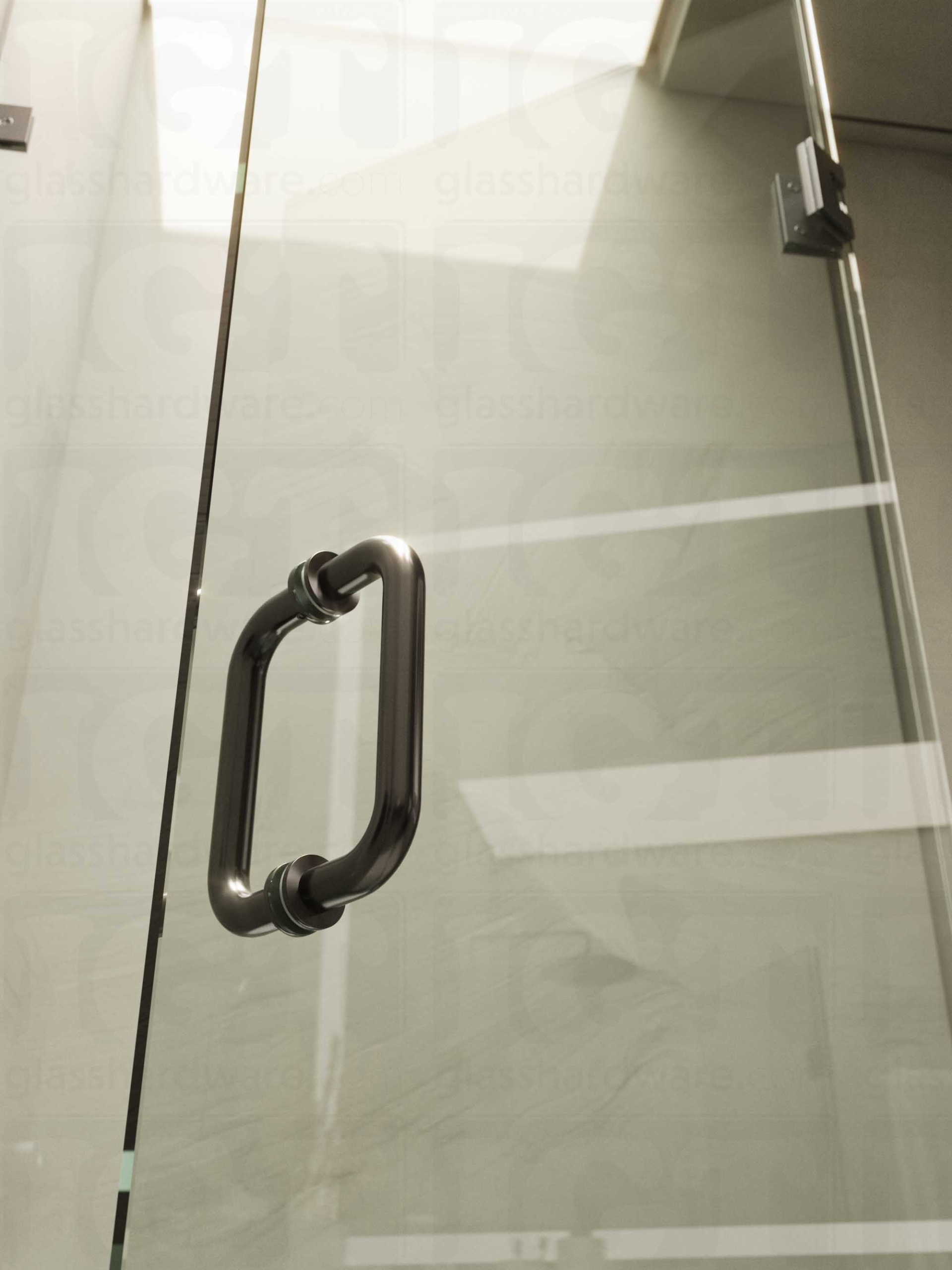 A close-up of the 6" Round Pull Handle installed on a frameless glass shower door, showcasing it's 304 Stainless Steel construction. Polished Gun Metal.