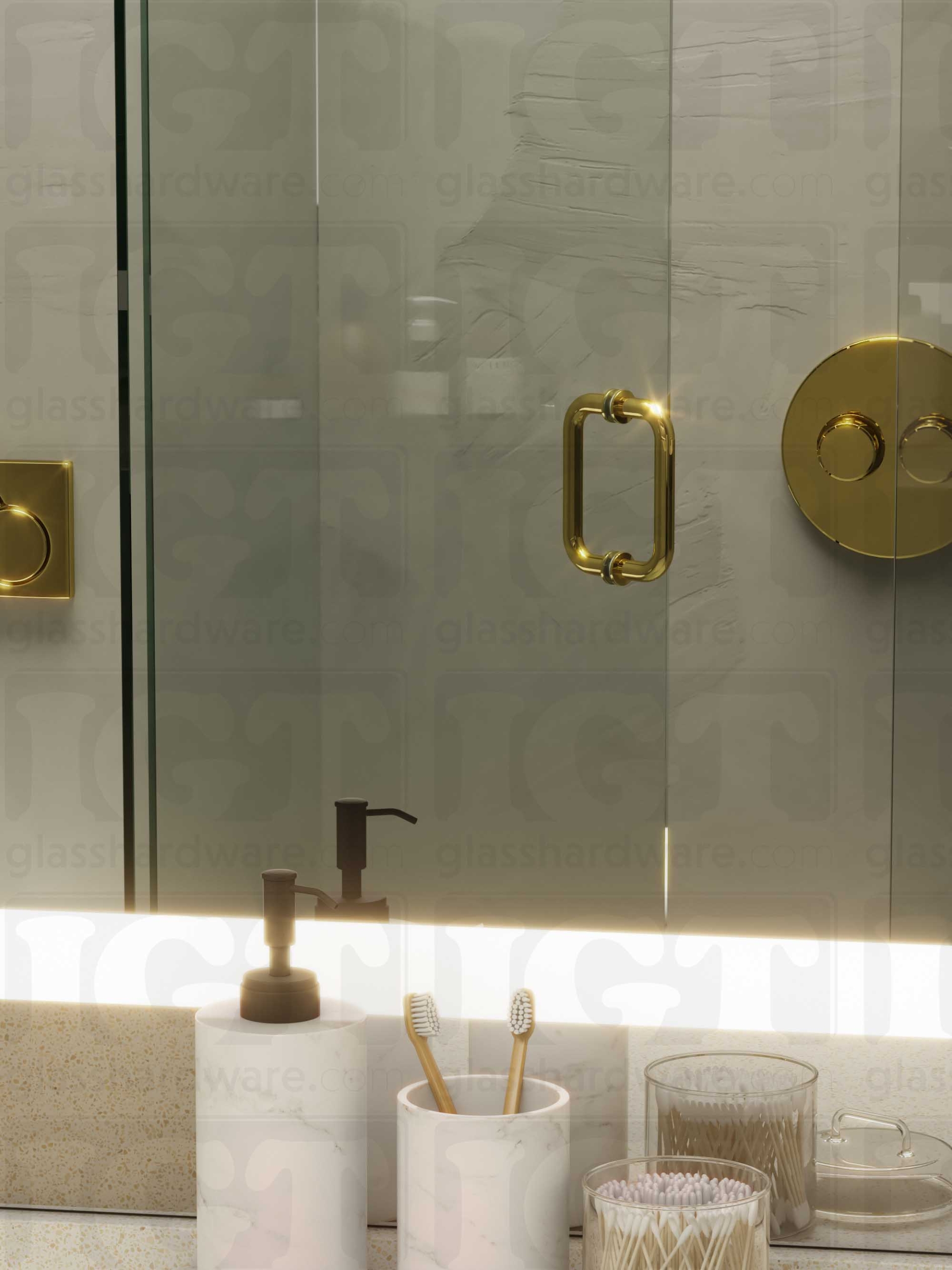 A frameless glass shower door in the open position, featuring the 6" Round Pull Handle. Polished Brass.