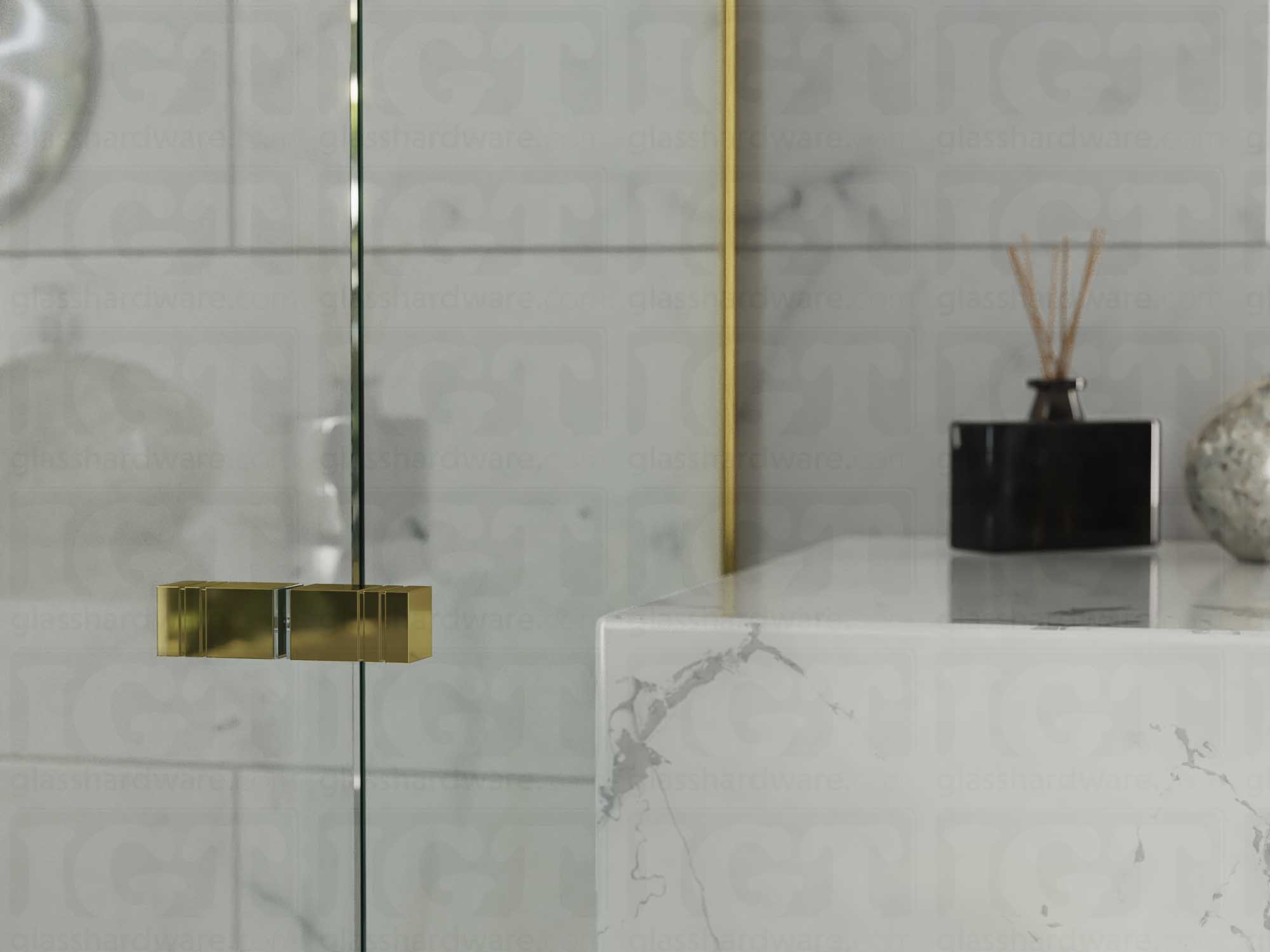 A close up of the Square Back-to-Back Door Knob installed on a glass shower door. The door knob's back-to-back design is tightly secured to the glass door. Gold Brushed.