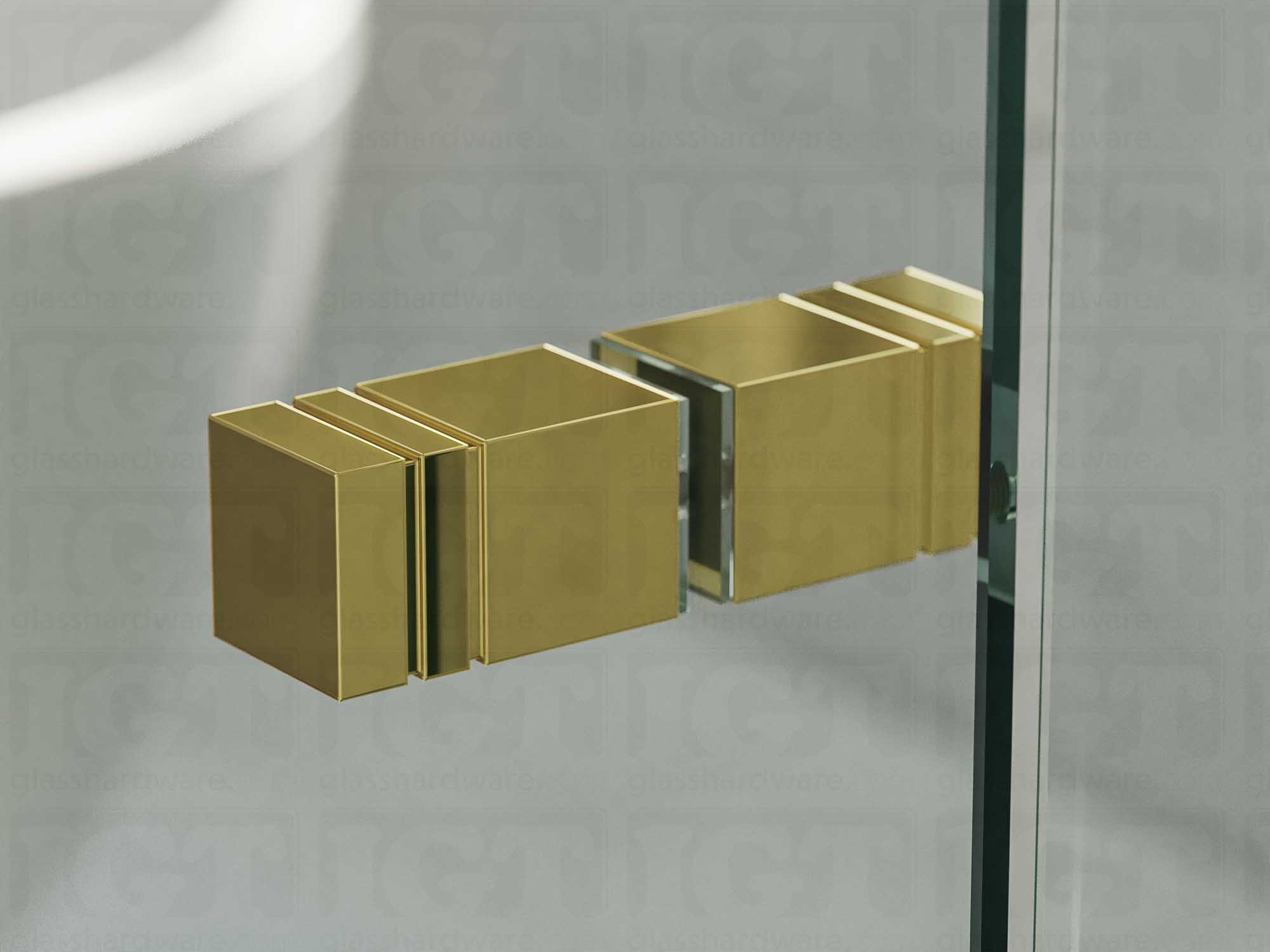 A close up of the Square Back-to-Back Door Knob installed on a glass shower door. Gold Brushed.