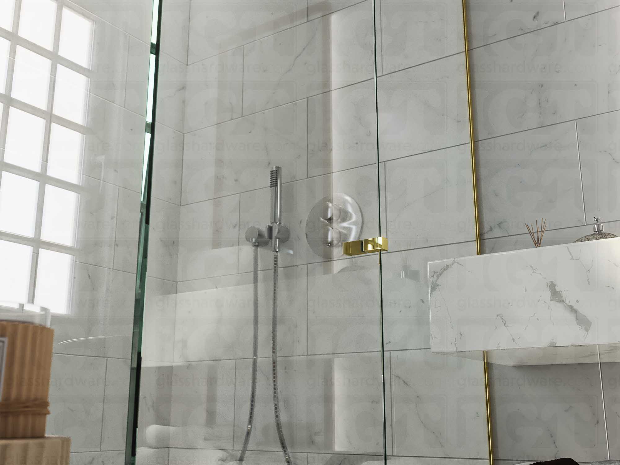 A close up of the Square Back-to-Back Door Knob installed on a glass shower door. Soft natural light highlights the knob's Gold Brushed finish.